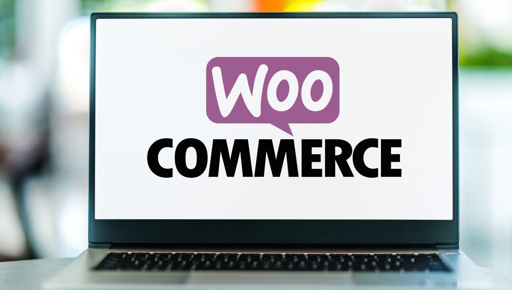 Open laptop displaying the WooCommerce logo