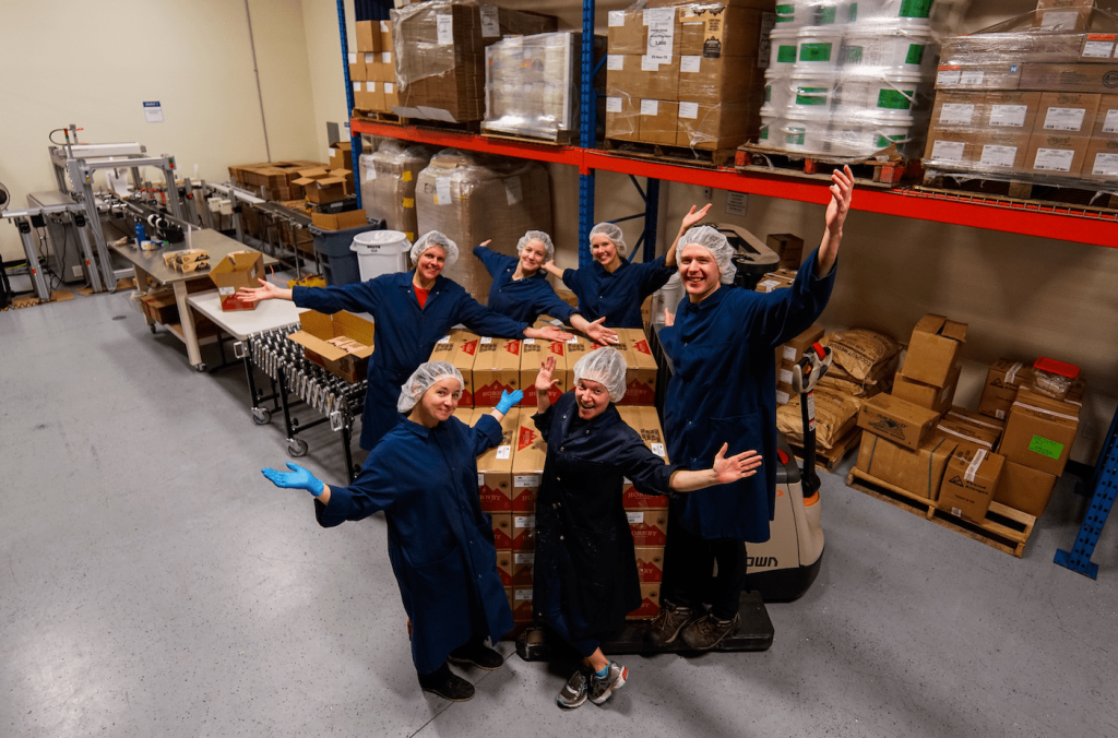 Hornby organic team in the factory standing around produce boxes