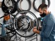 A man fixing bike tyre in a bike shop