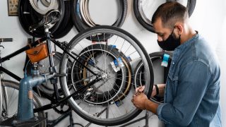 A man fixing bike tyre in a bike shop