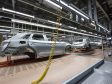 Automotive factory eith cars on a conveyer