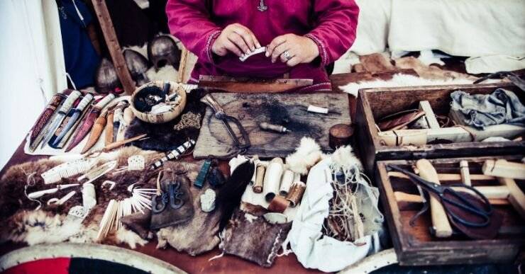 Native American using traditional tools and leather goods to make clothing. 