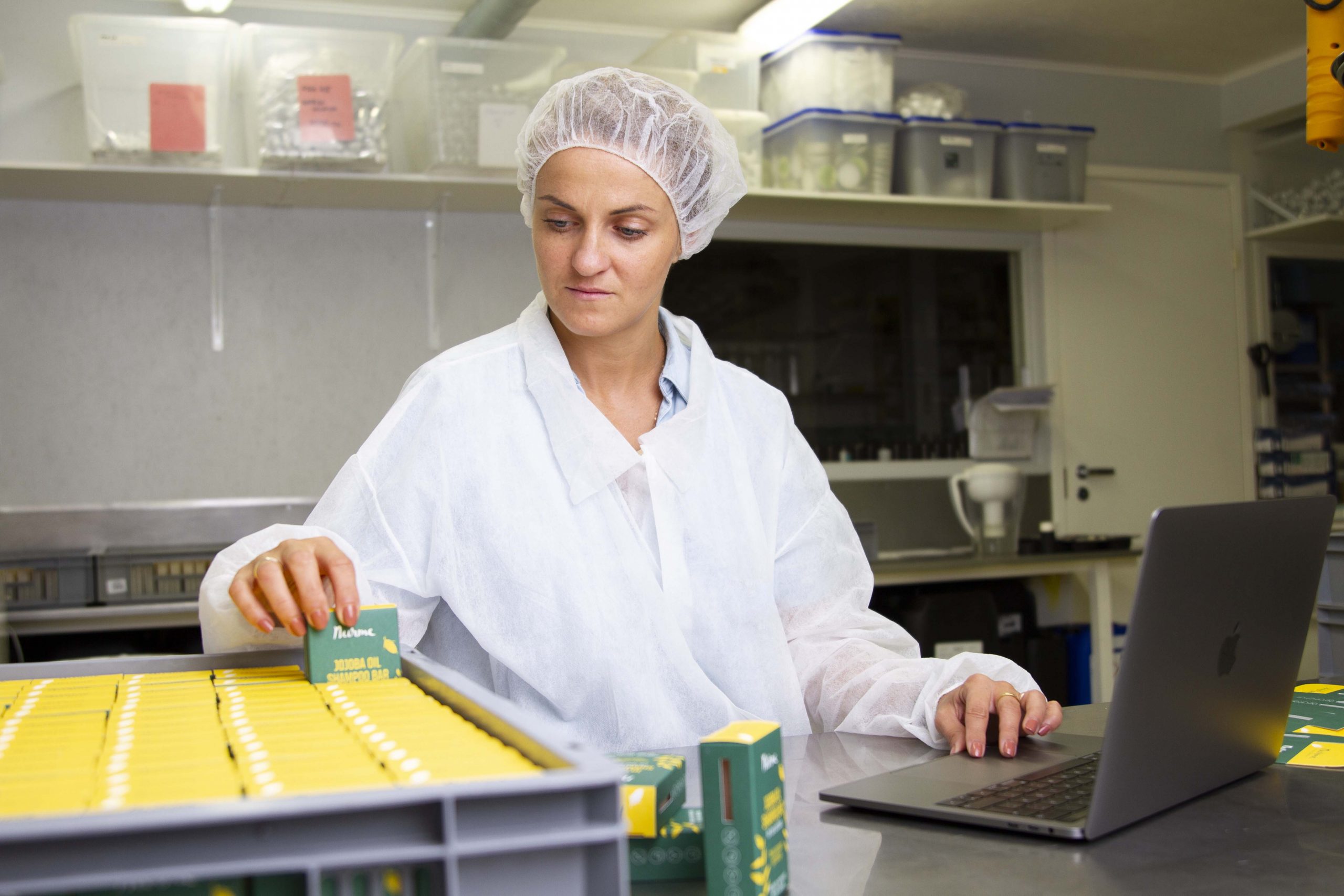 A factory worker counting inventory