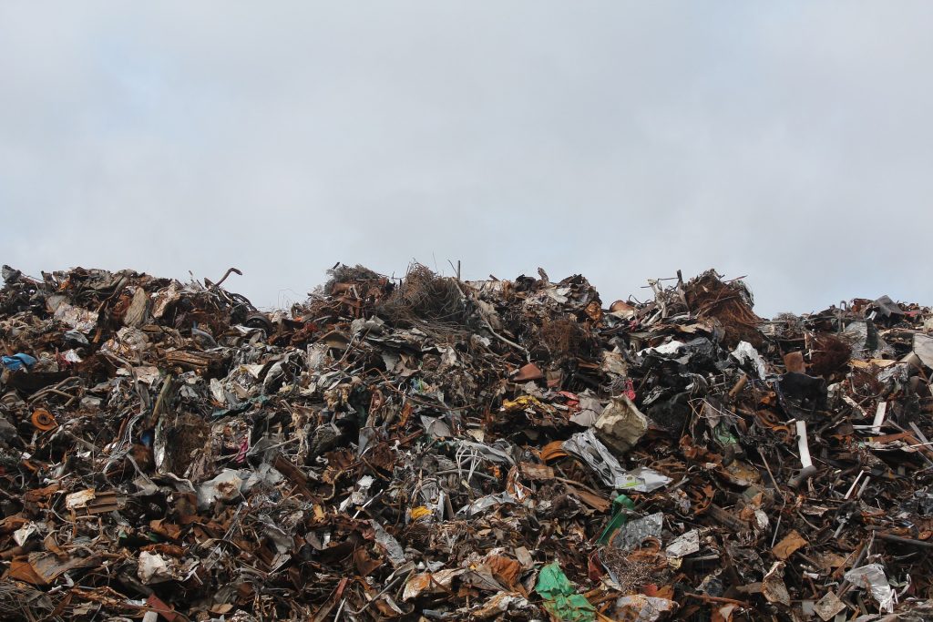 A big pile of trash at a junk yard. 