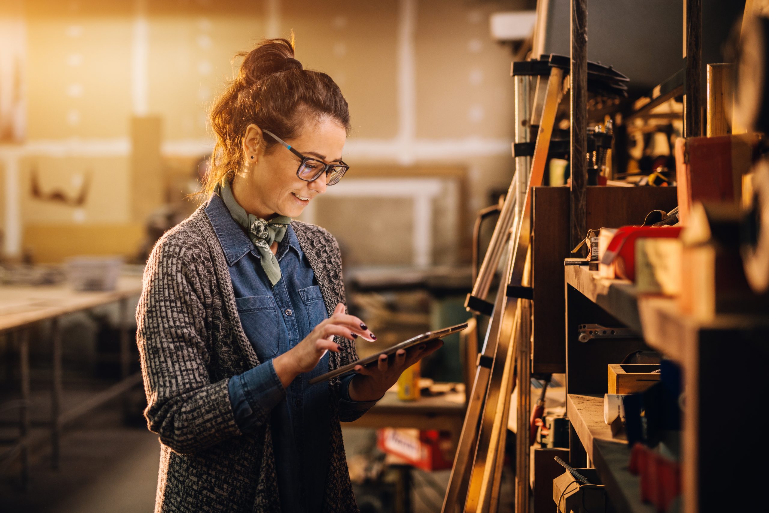 A woman updating her stock keeping numbers on her handheld device.