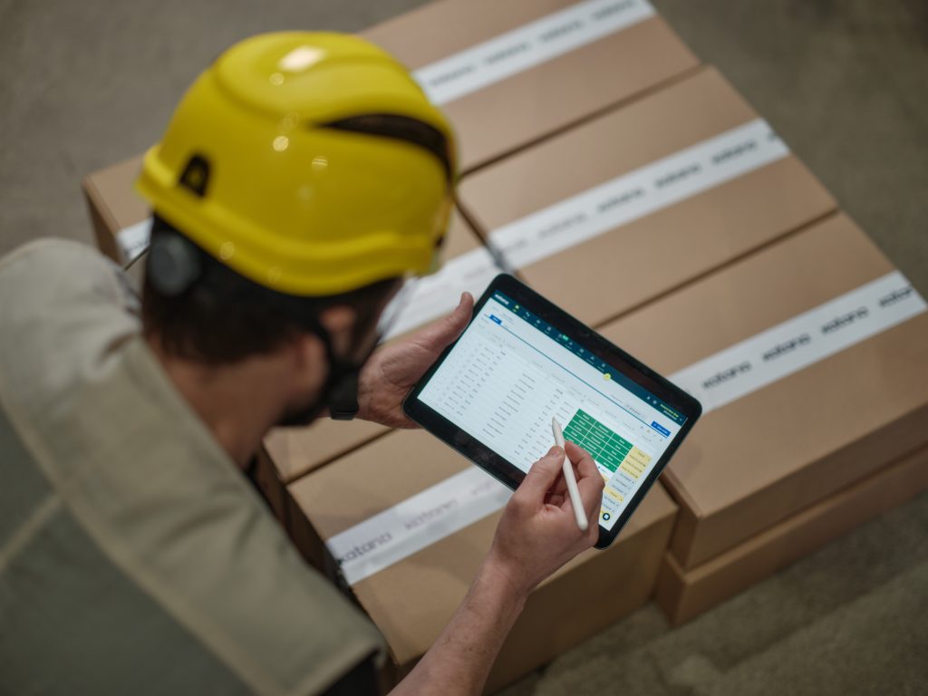 A warehouse worker navigating the Katana app and accepting inventory