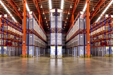Huge distribution warehouse with high shelves. Low angle view.