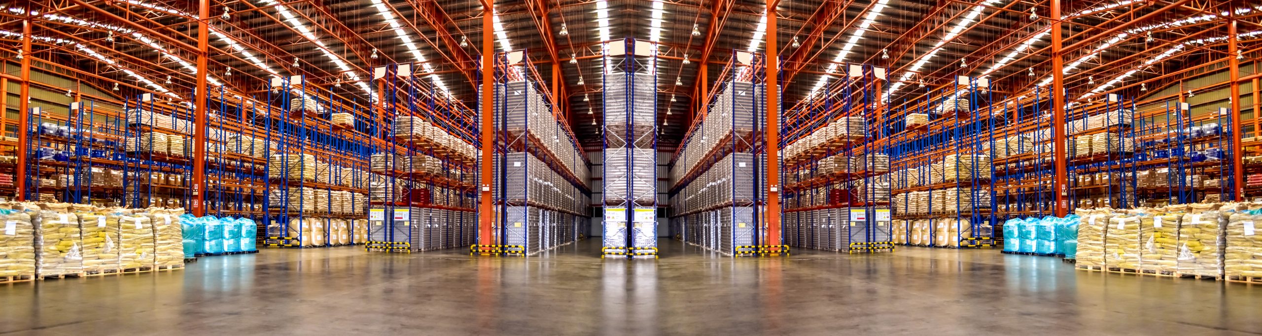 Huge distribution warehouse with high shelves. Low angle view.