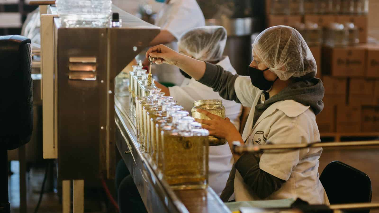 Workers checking bottles on the production line