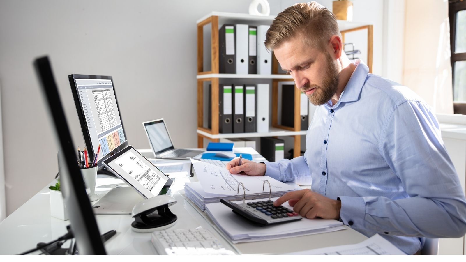 Man in the office calculating finished goods inventory