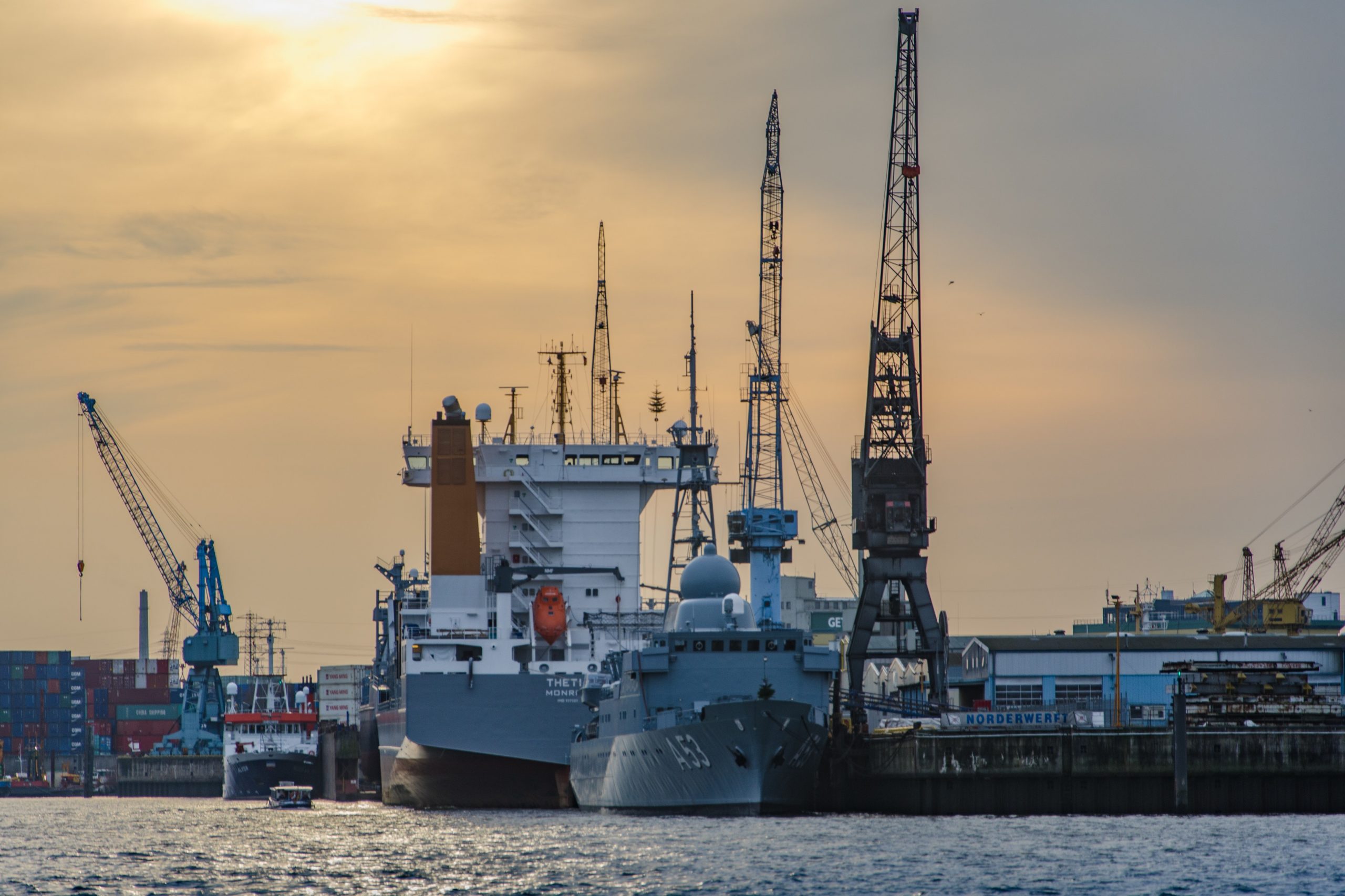 Industrial tower cranes loading a ship in port