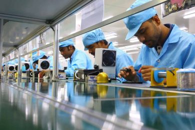 several men working along a linear production line that represents a cellular manufacturing set-up