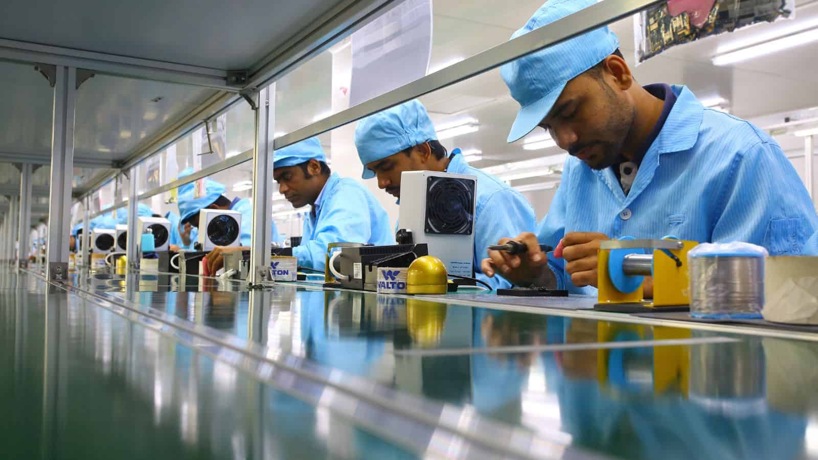 several men working along a linear production line that represents a cellular manufacturing set-up