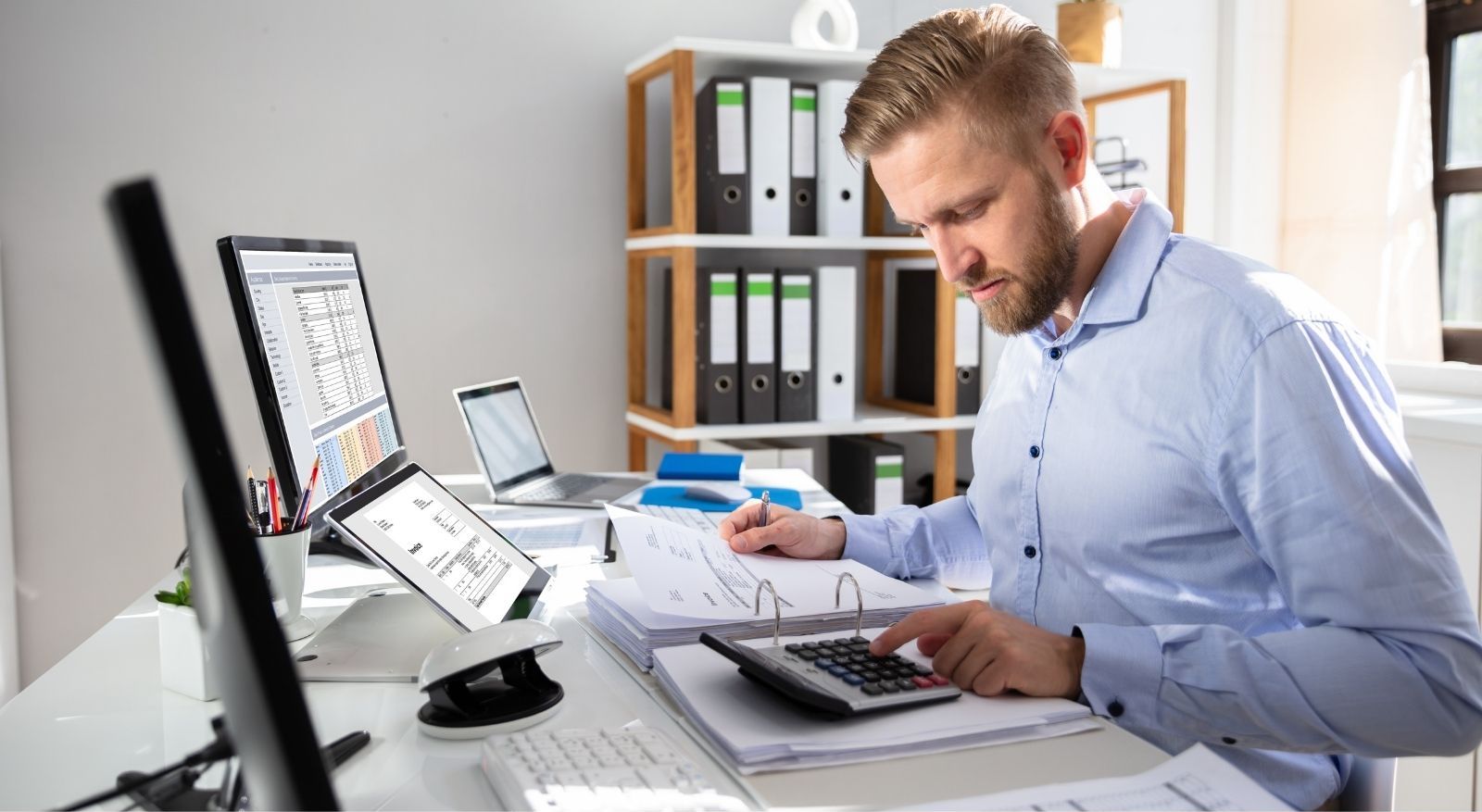 Man in the office calculating finished goods inventory