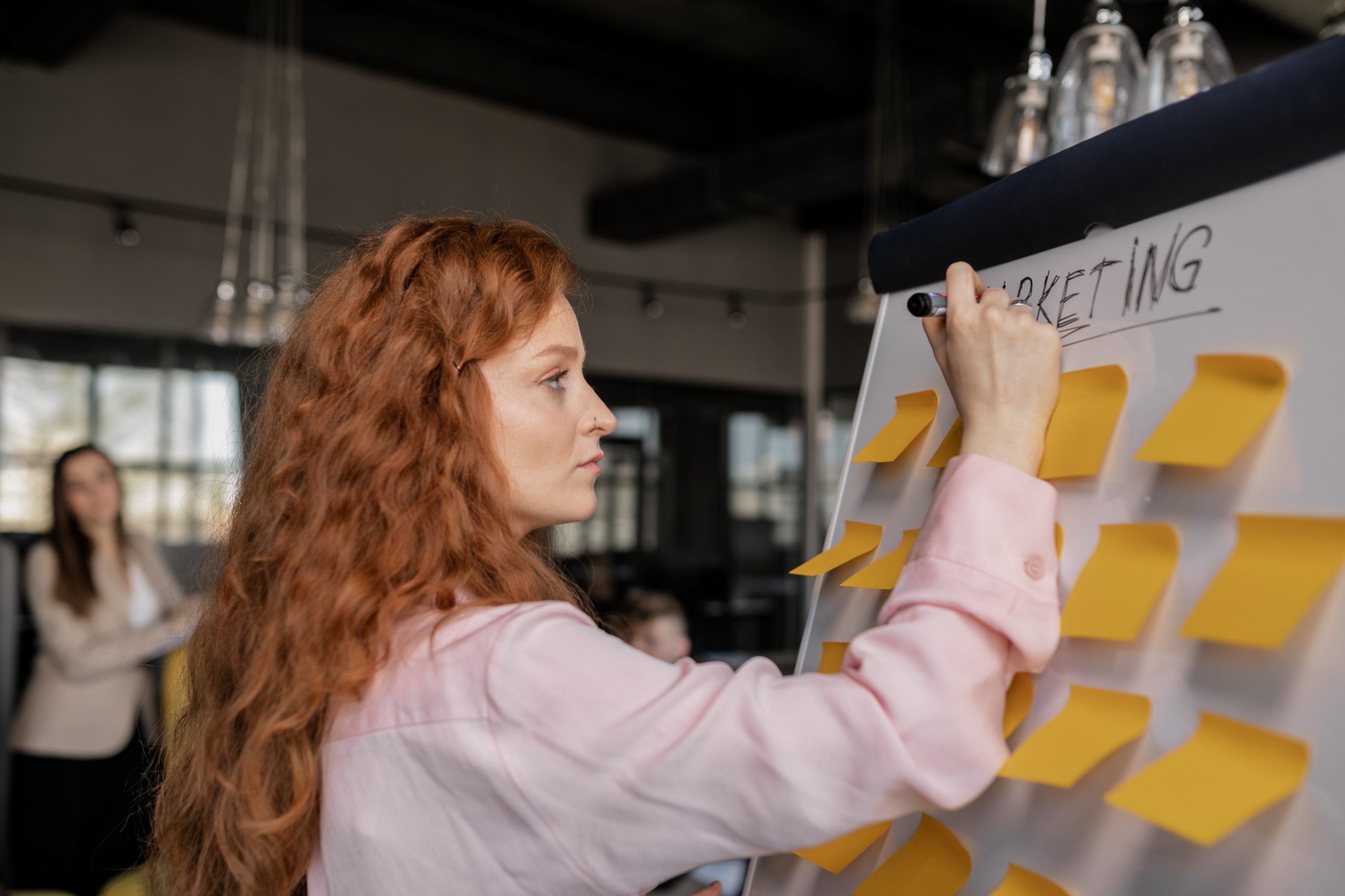 Woman writing on a whiteboard