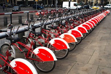 A row of parked red bicycles
