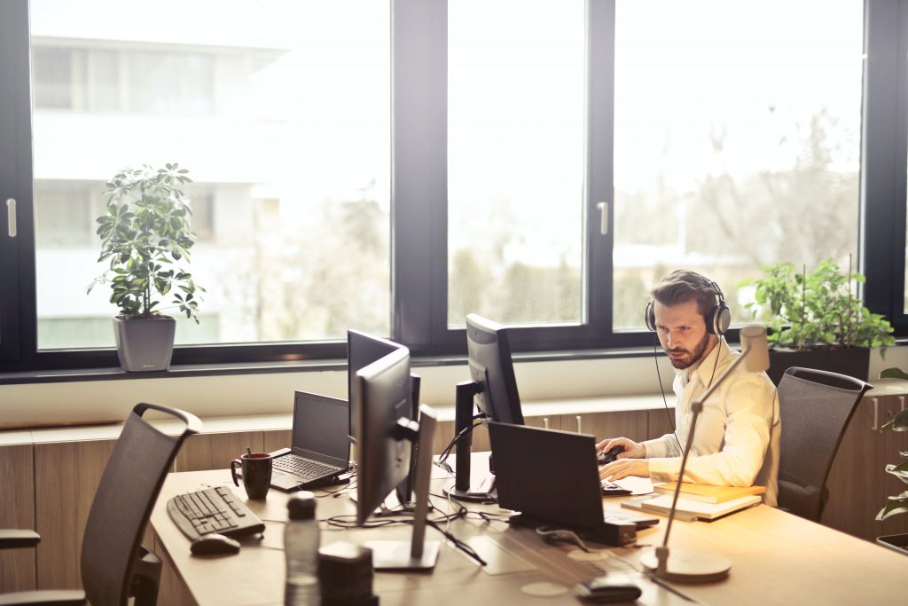 Customer support representative sitting at his desk with a headset
