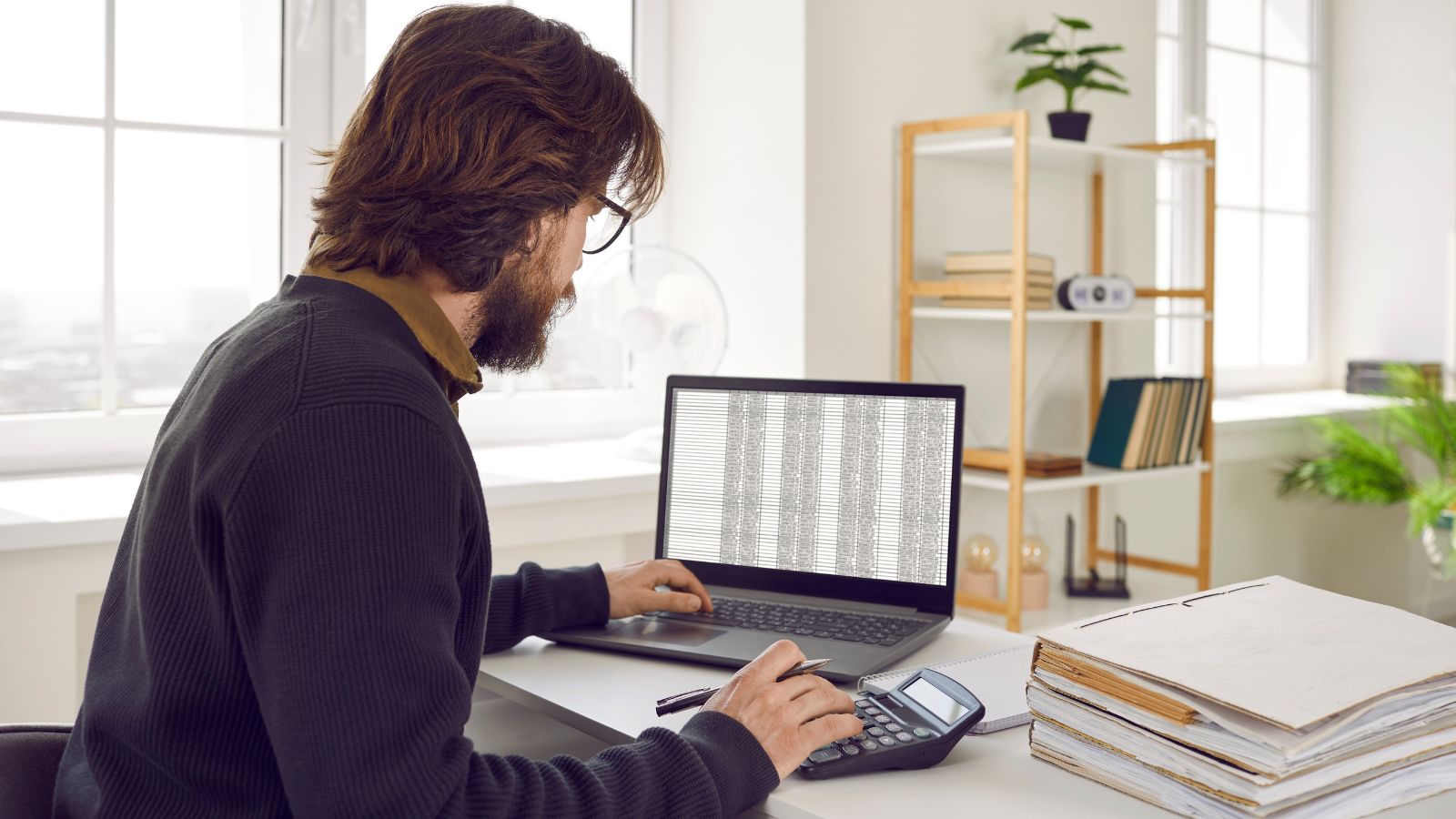 Accountant crunching numbers with a calculator