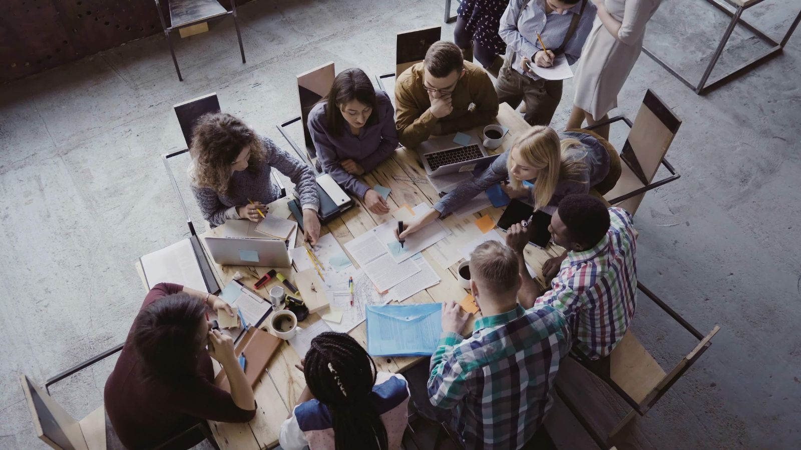 A team of workers coming together for project management for manufacturing.