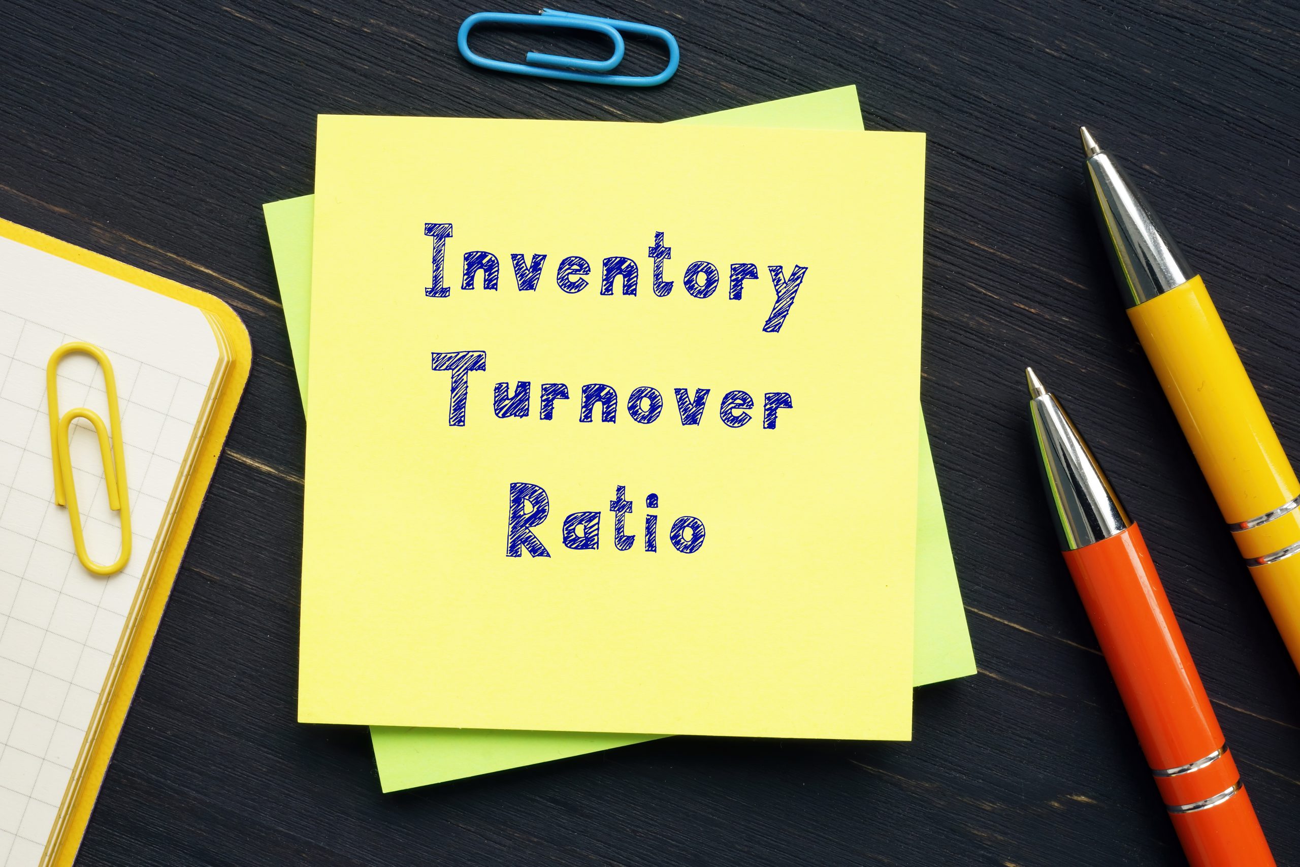 "Inventory turnover ratio: written on a Post-it note on a desk