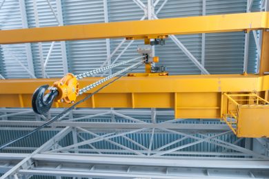 Yellow overhead crane in a large warehouse