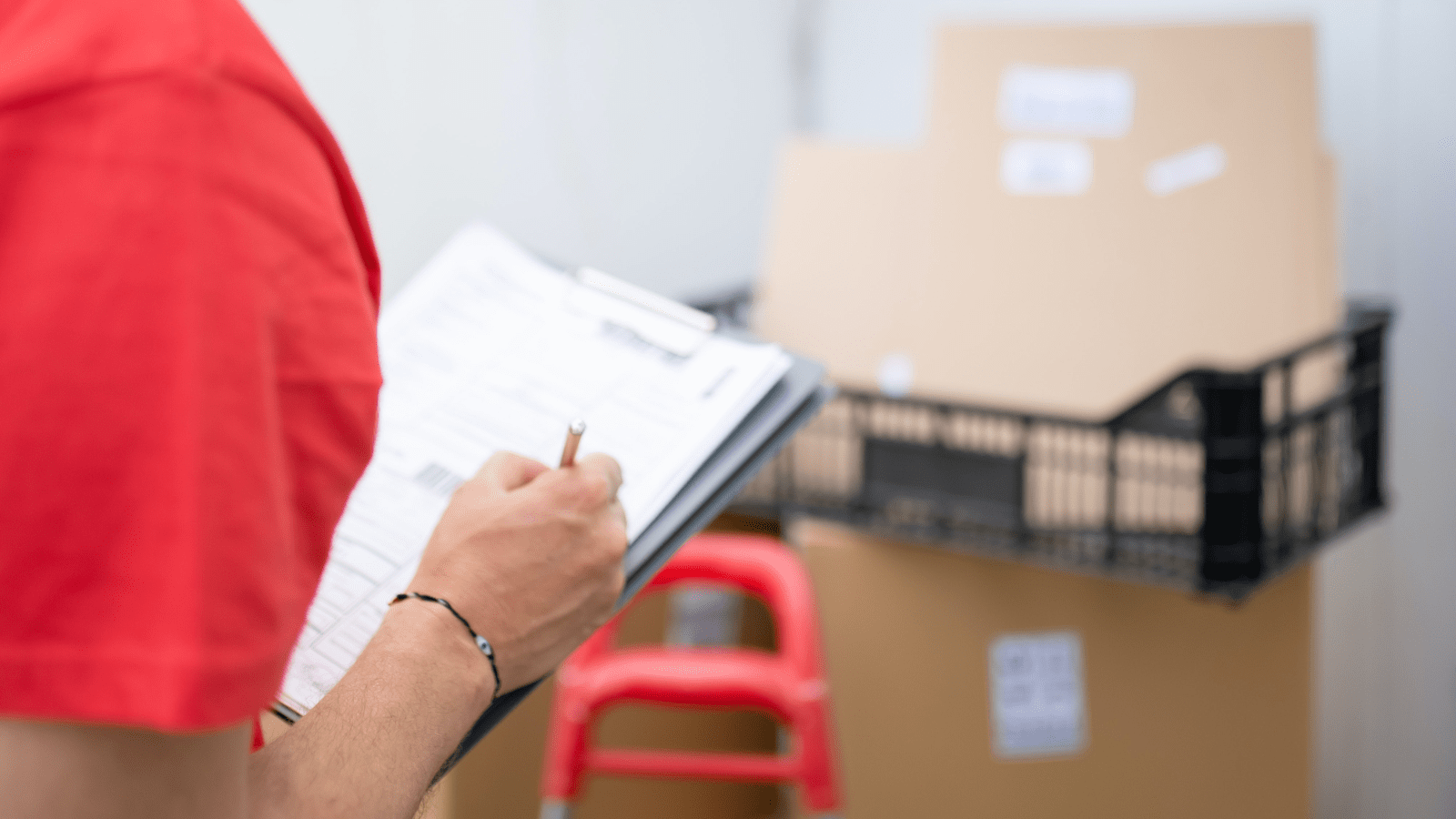 Man filling in a quality control checklist for manufacturing