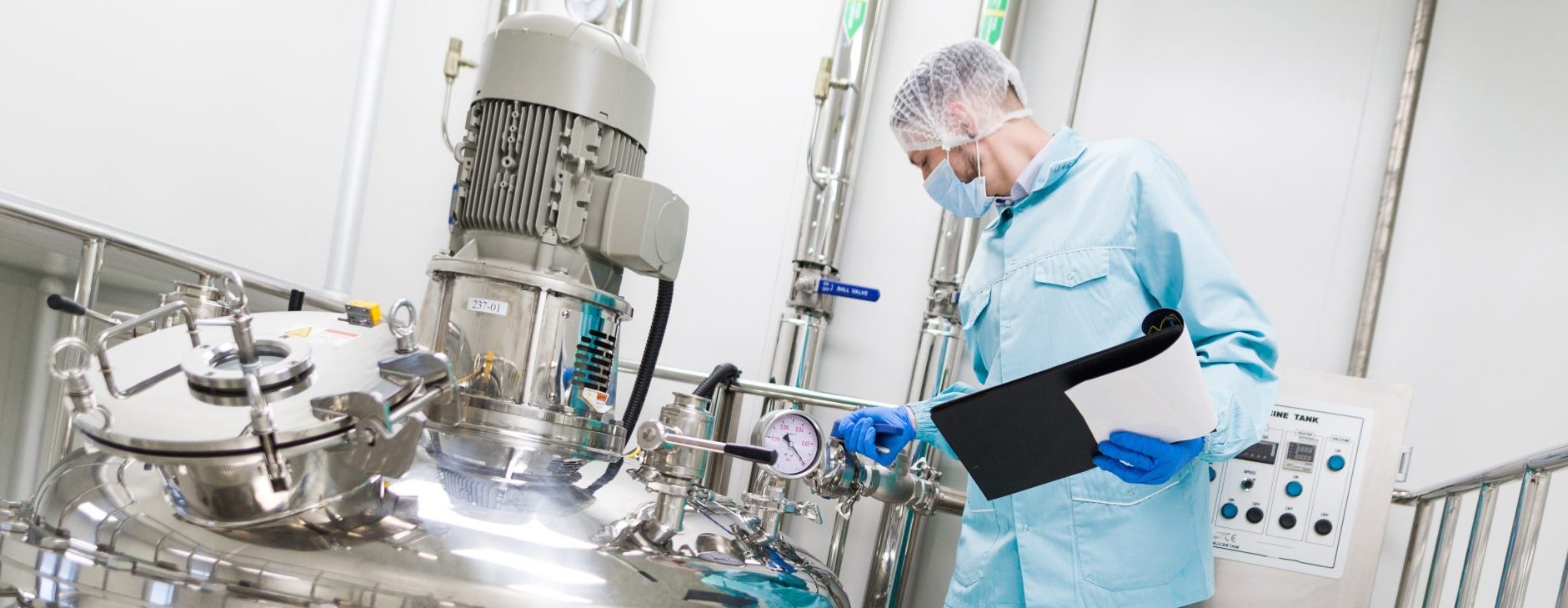 A worker wearing protective gear in a food and beverage manufacturing plant