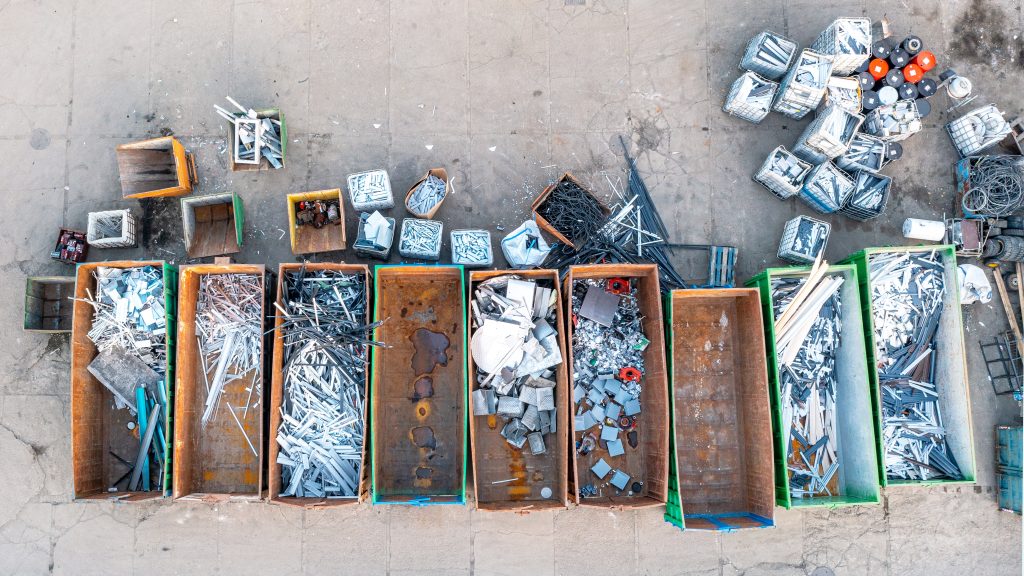 Top view of large scrap containers next to each other, each filled with different metal scrap
