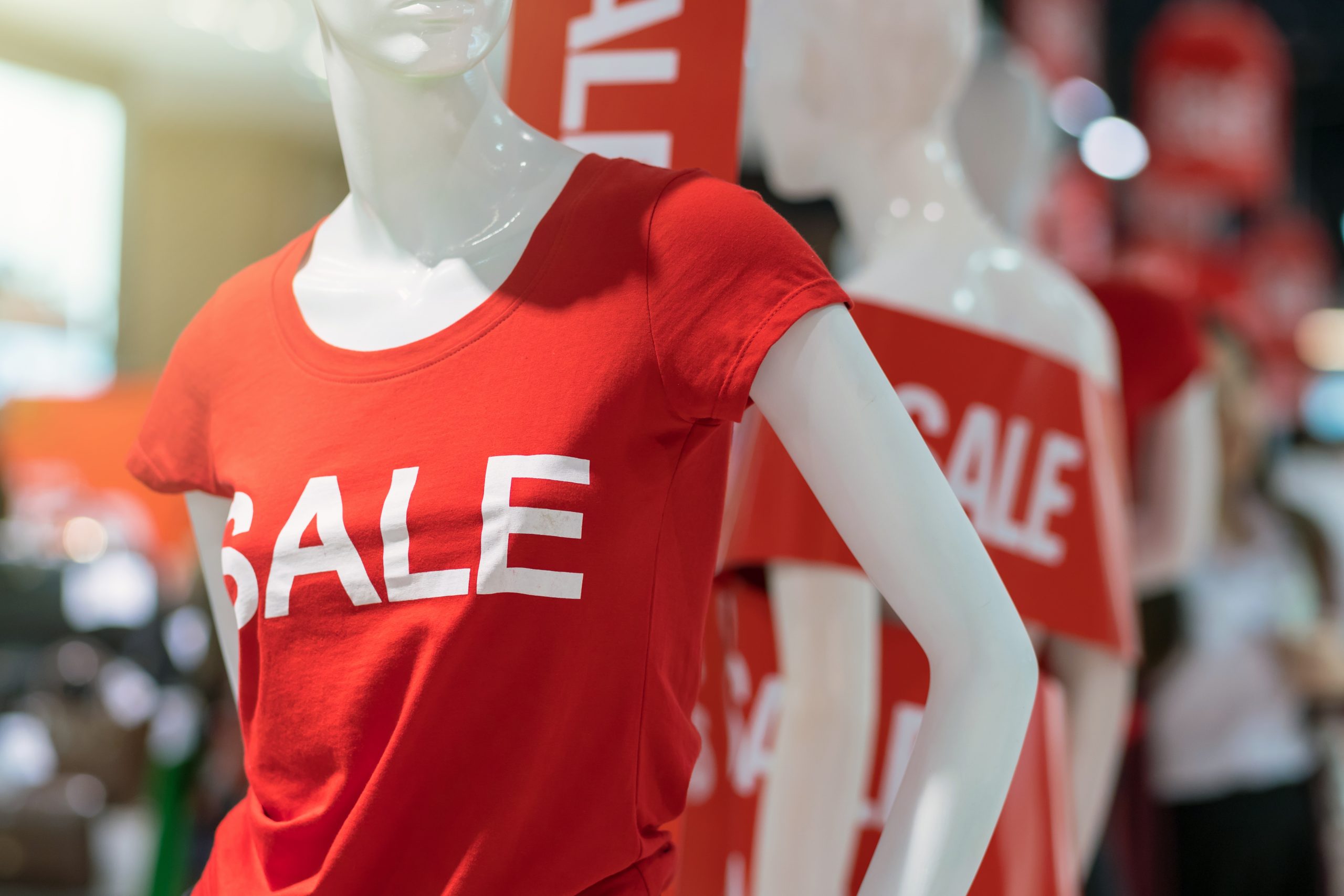 Mannequin in a red shirt with "SALE" written on it