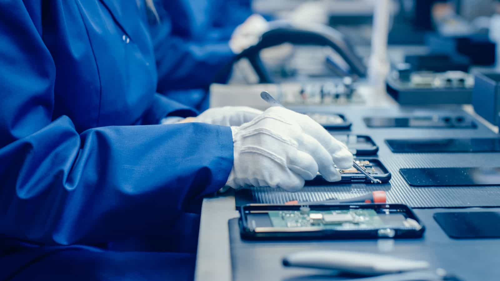 Workers on a manufacturing assembly line performing different tasks.