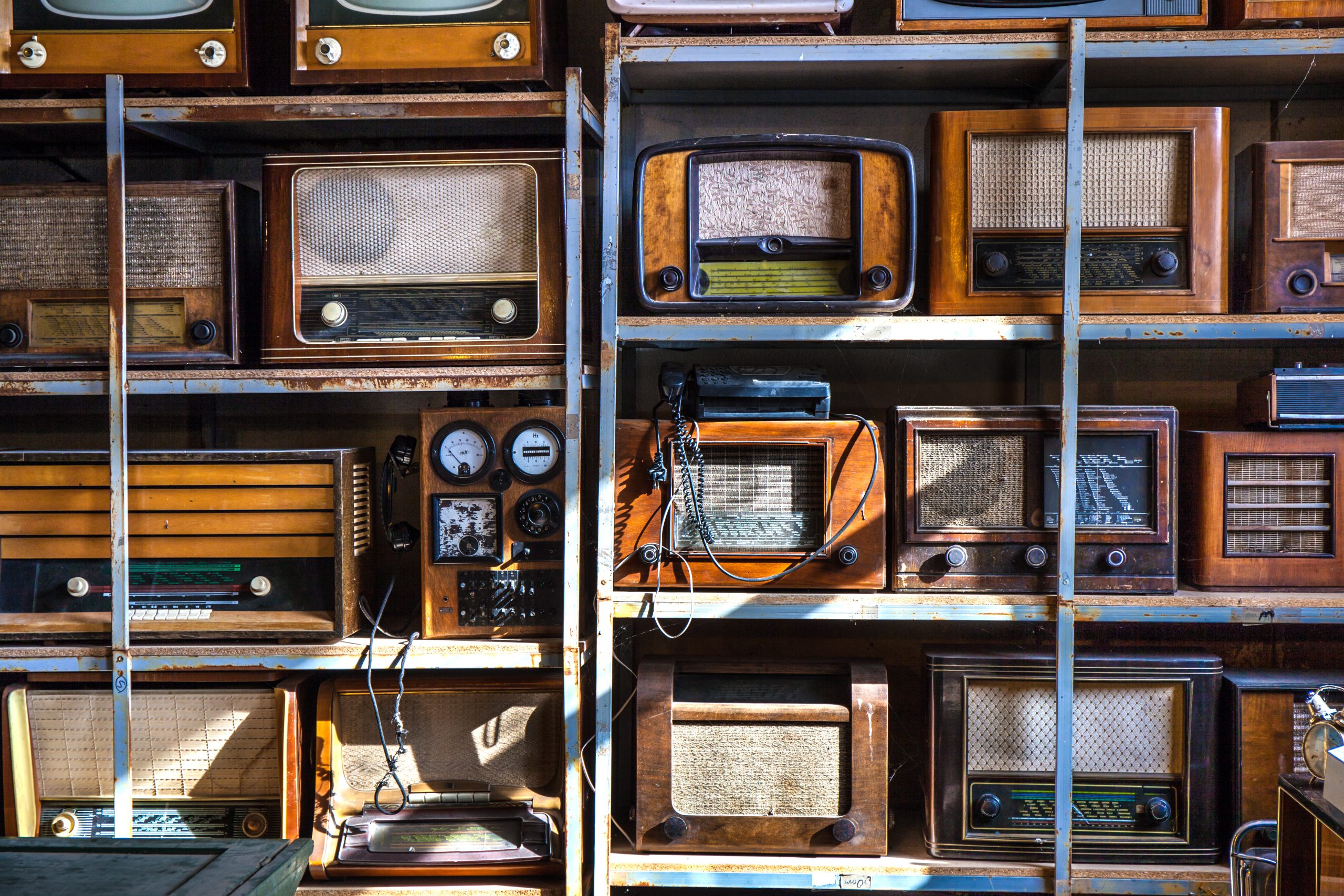Dust shelves in a store holding old radio equipment