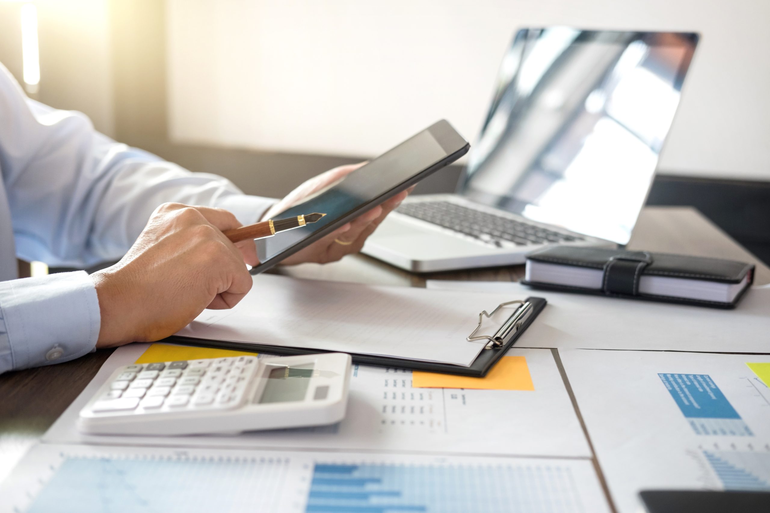 Businessman using tablet and doing finances