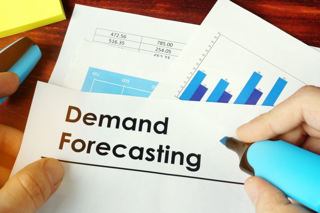 Closeup of demand forecasting documents showing business metrics