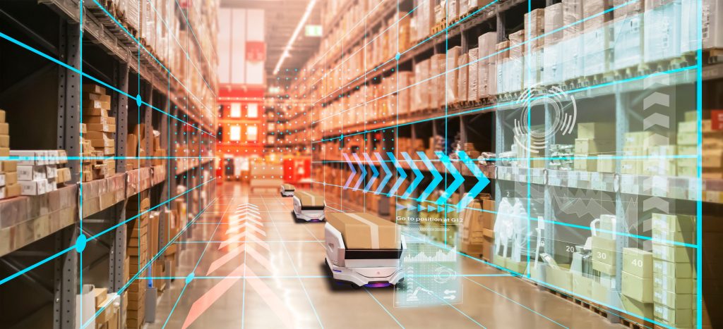 Robots moving around boxes in a warehouse between shelves stacked with inventory