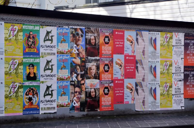 Different posters stuck on wall in Amsterdam