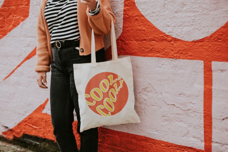 Woman carrying a reusable canvas tote bag